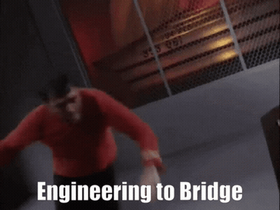 A Man In A Red Shirt Is Leaning On A Table With The Words Engineering To Bridge Written On The Bottom GIF