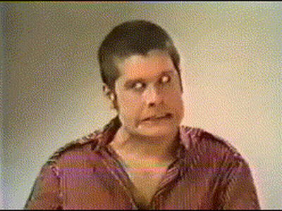 A Man In A Red Shirt Is Making A Face GIF
