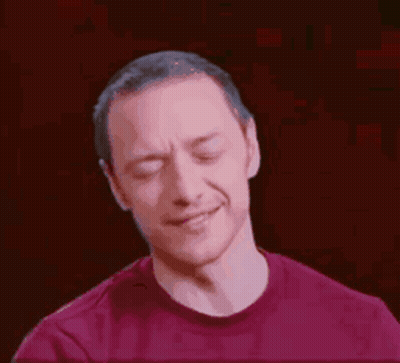 A Man In A Red Shirt Is Making A Face With His Eyes Closed . GIF