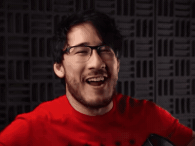 A Man In A Red Shirt Is Making A Funny Face GIF