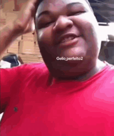 A Man In A Red Shirt Is Making A Funny Face And Has The Hashtag Gellio_perfeito2 On His Neck GIF