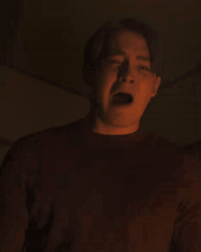 A Man In A Red Shirt Is Making A Funny Face With His Mouth Open GIF