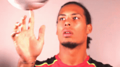 A Man In A Red Shirt Is Playing With A Ball GIF