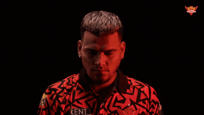A Man In A Red Shirt Is Pointing At Something GIF