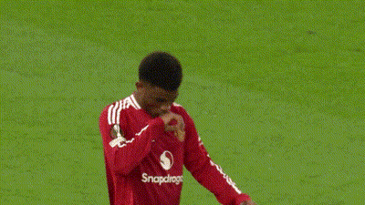 A Man In A Red Shirt Is Pointing Up In The Air . GIF