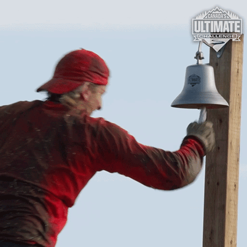 A Man In A Red Shirt Is Ringing A Bell With A Canada Ultimate Challenge Logo In The Background GIF