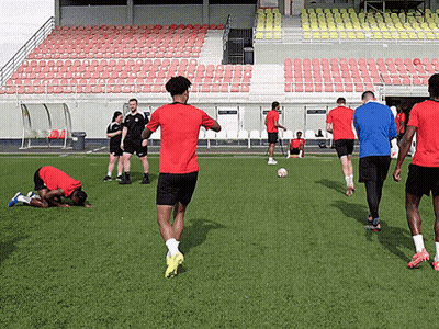A Man In A Red Shirt Is Running On A Field GIF