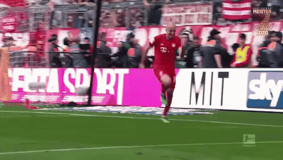 A Man In A Red Shirt Is Running On A Soccer Field In Front Of A Sky Ad GIF