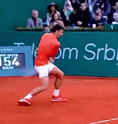 A Man In A Red Shirt Is Running On A Tennis Court With A Sign That Says 154 Km / H GIF