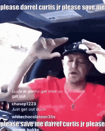 A Man In A Red Shirt Is Sitting In A Car Asking For Help GIF