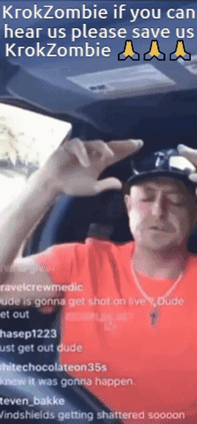 A Man In A Red Shirt Is Sitting In A Car With The Words Krokzombie If You Can Hear Us Please Save Us GIF