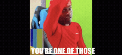 A Man In A Red Shirt Is Sitting In A Chair With The Words You 'Re One Of Those Above Him . GIF