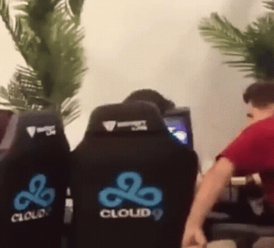 A Man In A Red Shirt Is Sitting In A Cloud 9 Chair . GIF