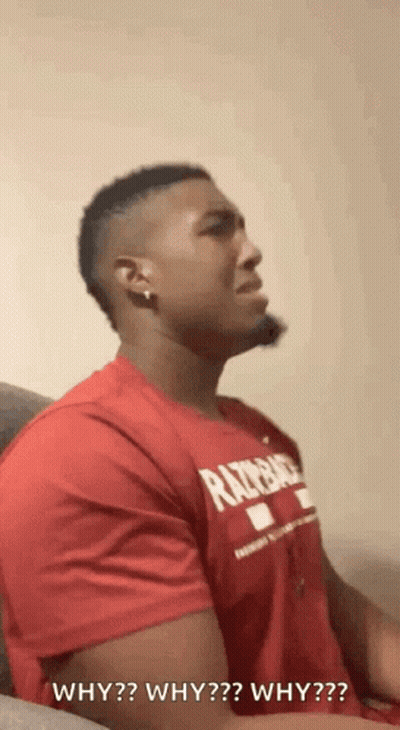 A Man In A Red Shirt Is Sitting On A Couch And Asking Why Why Why Why ? GIF
