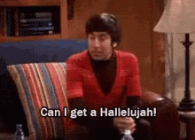 A Man In A Red Shirt Is Sitting On A Couch And Saying Can I Get A Hallelujah ! GIF