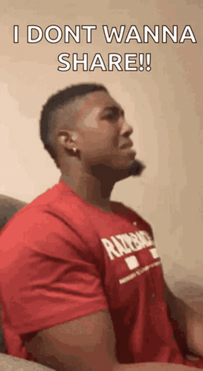 A Man In A Red Shirt Is Sitting On A Couch And Says `` I Dont Wanna Share '' . GIF