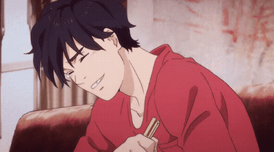 A Man In A Red Shirt Is Sitting On A Couch Holding Chopsticks GIF