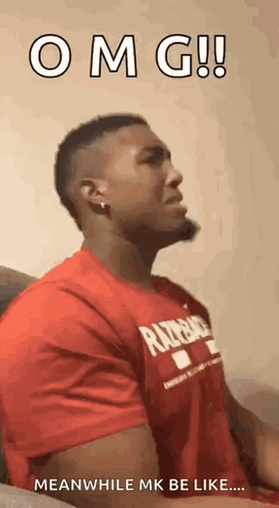 A Man In A Red Shirt Is Sitting On A Couch With His Mouth Open . GIF