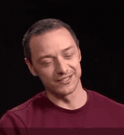 A Man In A Red Shirt Is Smiling And Making A Face . GIF