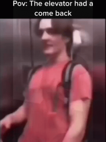 A Man In A Red Shirt Is Standing In An Elevator And The Elevator Had A Comeback . GIF