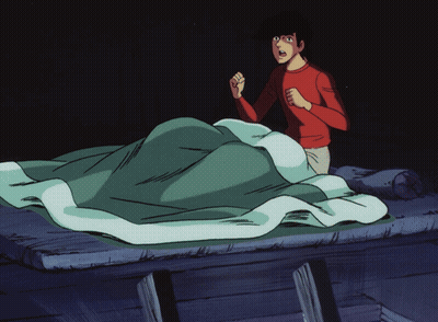 A Man In A Red Shirt Is Standing In Front Of A Bed GIF