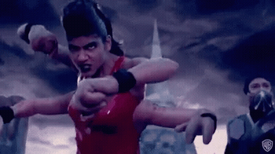 A Man In A Red Shirt Is Standing In Front Of A Group Of People And Pointing At Them . GIF
