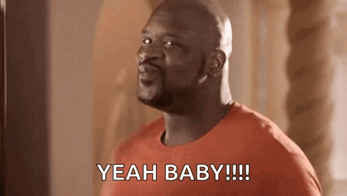 A Man In A Red Shirt Is Standing In Front Of A Mirror And Saying `` Yeah Baby '' . GIF