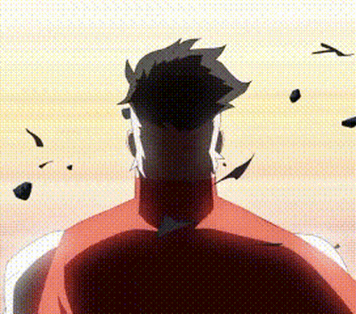A Man In A Red Shirt Is Standing In Front Of A Sunset With Rocks Flying Around Him . GIF