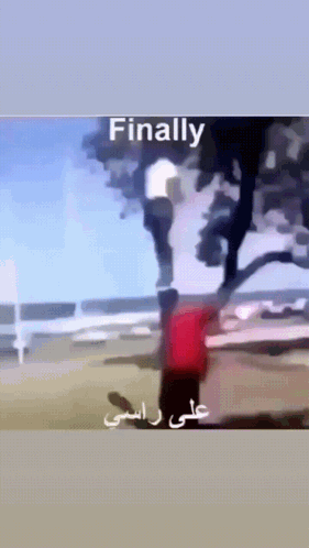 A Man In A Red Shirt Is Standing In Front Of A Tree And The Words Finally Are On The Bottom GIF