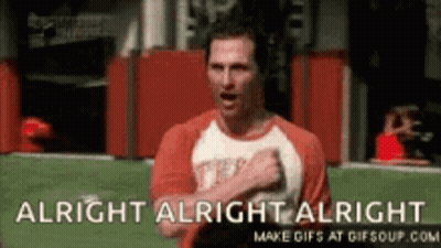 A Man In A Red Shirt Is Standing On A Field With His Hands On His Chest And The Words `` Alright Alright Alright '' . GIF