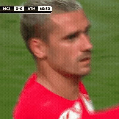 A Man In A Red Shirt Is Standing On A Soccer Field With A Score Of 0-0 Atm GIF