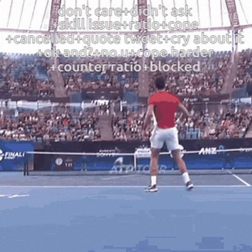 A Man In A Red Shirt Is Swinging A Tennis Racket On A Tennis Court GIF