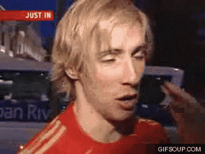 A Man In A Red Shirt Is Talking In Front Of A Sign That Says Just In On It GIF
