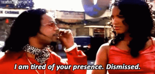 A Man In A Red Shirt Is Talking To A Woman In A Red Dress Who Is Dismissed . GIF