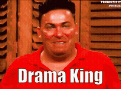 A Man In A Red Shirt Says " Drama King " On His Face GIF