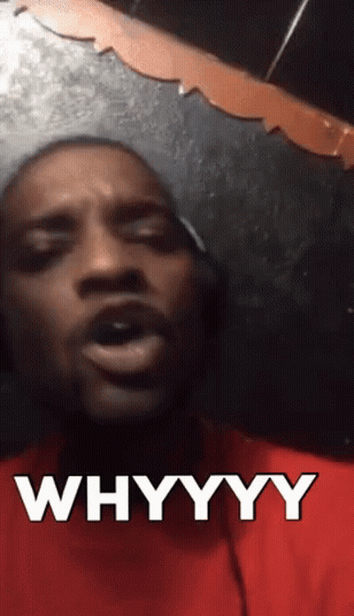 A Man In A Red Shirt Says Whyyyy In Front Of A Mirror GIF