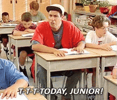 A Man In A Red Shirt Sits At A Desk In A Classroom With The Words T-T-T-Today Junior GIF