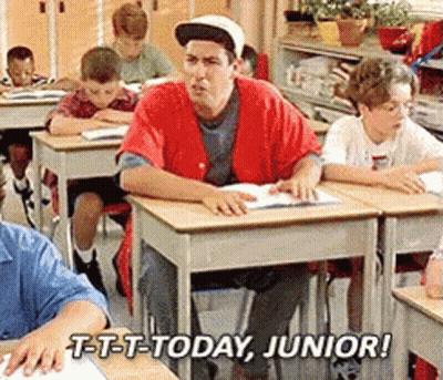 A Man In A Red Shirt Sits At A Desk In A Classroom With The Words T-T-T-Today Junior GIF