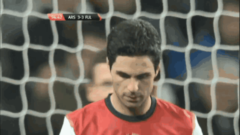 A Man In A Red Shirt Stands In Front Of A Soccer Net With A Score Of 4-3 GIF