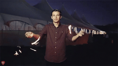 A Man In A Red Shirt Stands In Front Of A Tent With A Fl Logo On The Bottom GIF