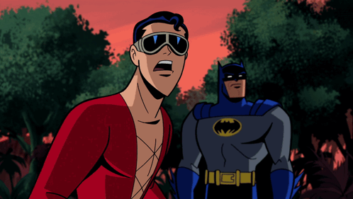 A Man In A Red Shirt Stands Next To A Man In A Batman Suit GIF