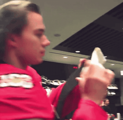 A Man In A Red Shirt With A Chevrolet Logo On His Arm GIF