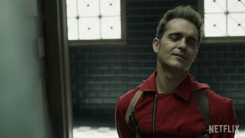 A Man In A Red Shirt With A Netflix Logo On The Bottom GIF