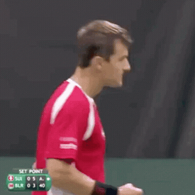 A Man In A Red Shirt With A Swiss Cross On It Is Shouting . GIF