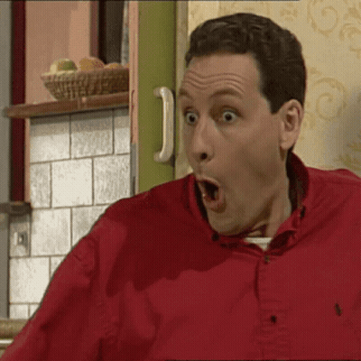 A Man In A Red Shirt With His Mouth Wide Open GIF