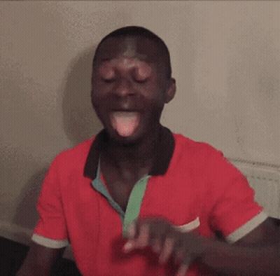 A Man In A Red Shirt With His Tongue Out GIF