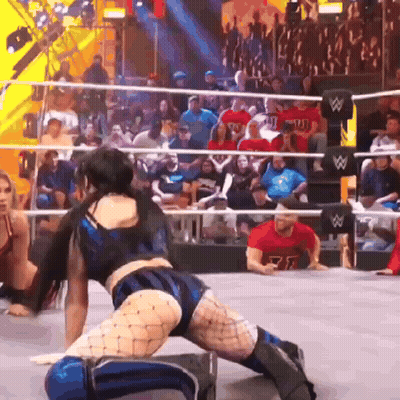 A Man In A Red Shirt With The Letter R On It Is Watching A Wrestling Match GIF