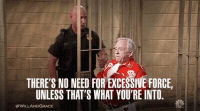 A Man In A Red Shirt With The Number 8 On It Behind Bars GIF