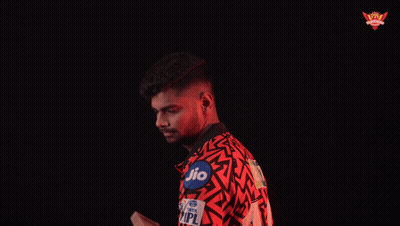 A Man In A Red Shirt With The Word Her On It Is Holding A Bat GIF