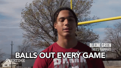 A Man In A Red Shirt With The Words " Balls Out Every Game " On It GIF